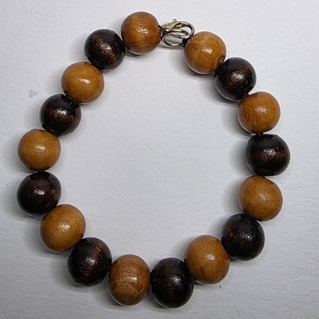 Beaded bracelet with brown and black beads on a white background