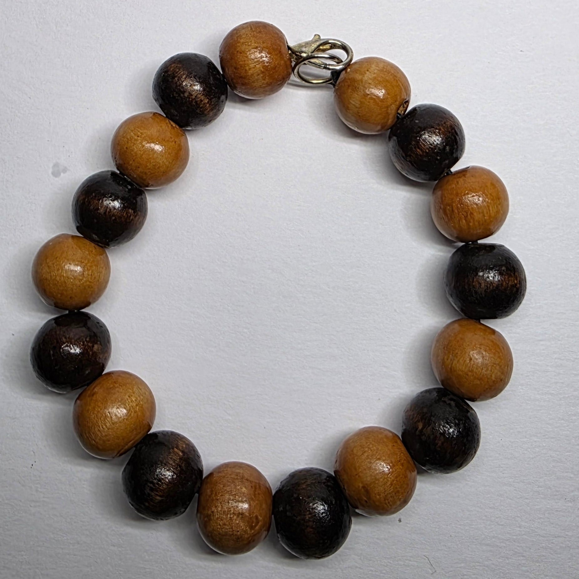Beaded bracelet with brown and black beads on a white background