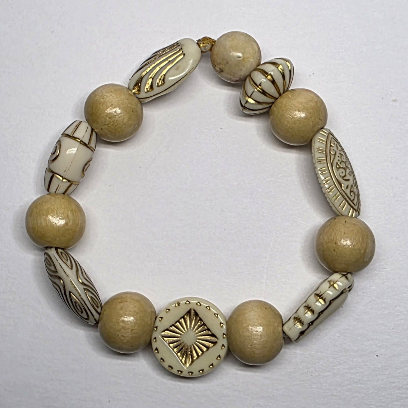 Beaded bracelet with decorative elements on a light gray background